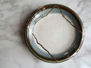 Repaired ceramic plate with visible fracture lines sealed and reinforced, illustrating repair-before-replacement logic and durability under scarcity constraints.