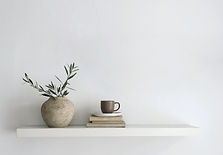Tunisian ceramic vessel and everyday objects arranged on a minimal shelf