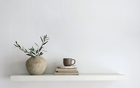 Tunisian ceramic vessel and everyday objects arranged on a minimal shelf