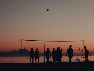 Group of friends playing beach volleyball at sunset in Tunisia, reflecting the country’s warm, relaxed travel atmosphere.