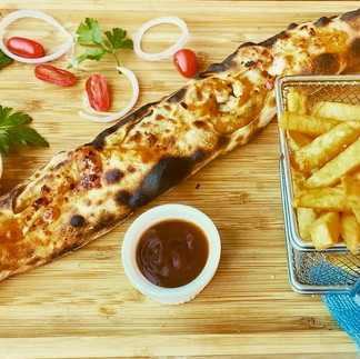 Baguette farcie with melted cheese inside a toasted baguette, served with fries and sauce