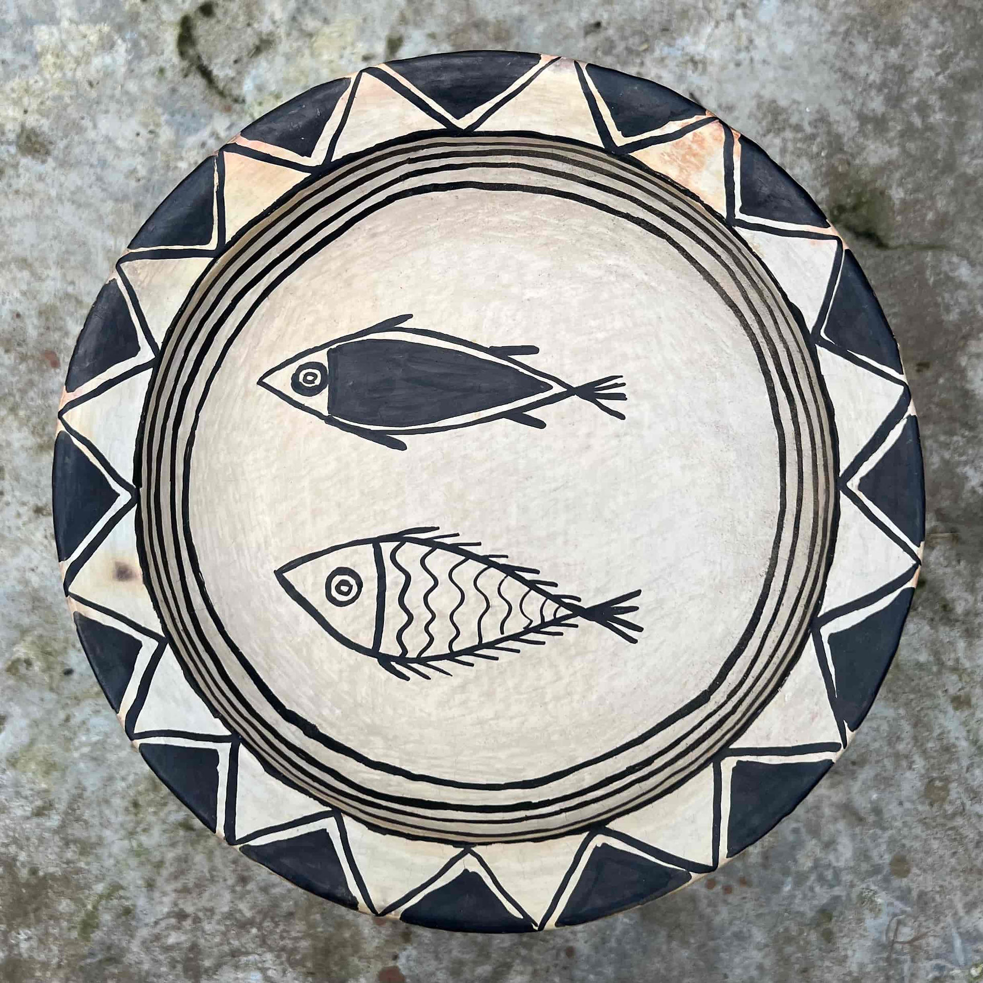 Hand-built Sejnane bowl decorated with two fish and geometric rim markings.