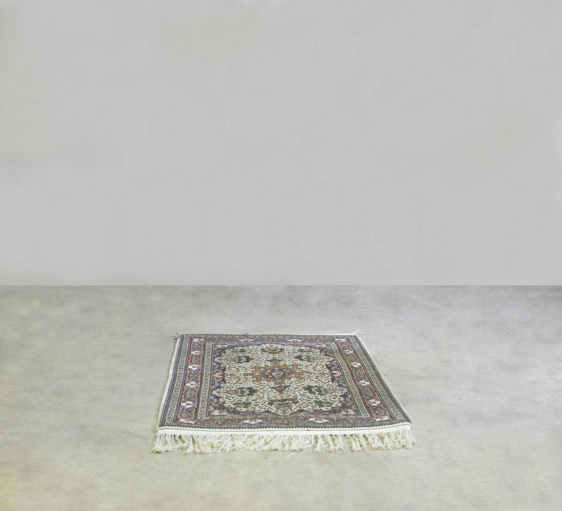 Handwoven Tunisian rug placed in a minimal interior space showing domestic textile craftsmanship