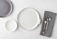 Handmade Tunisian ceramic bowls, plates, and serving pieces arranged for everyday meals and shared table use.