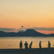 People gathering on a beach at sunset in Tunisia, illustrating the relaxed rhythm of coastal public life.