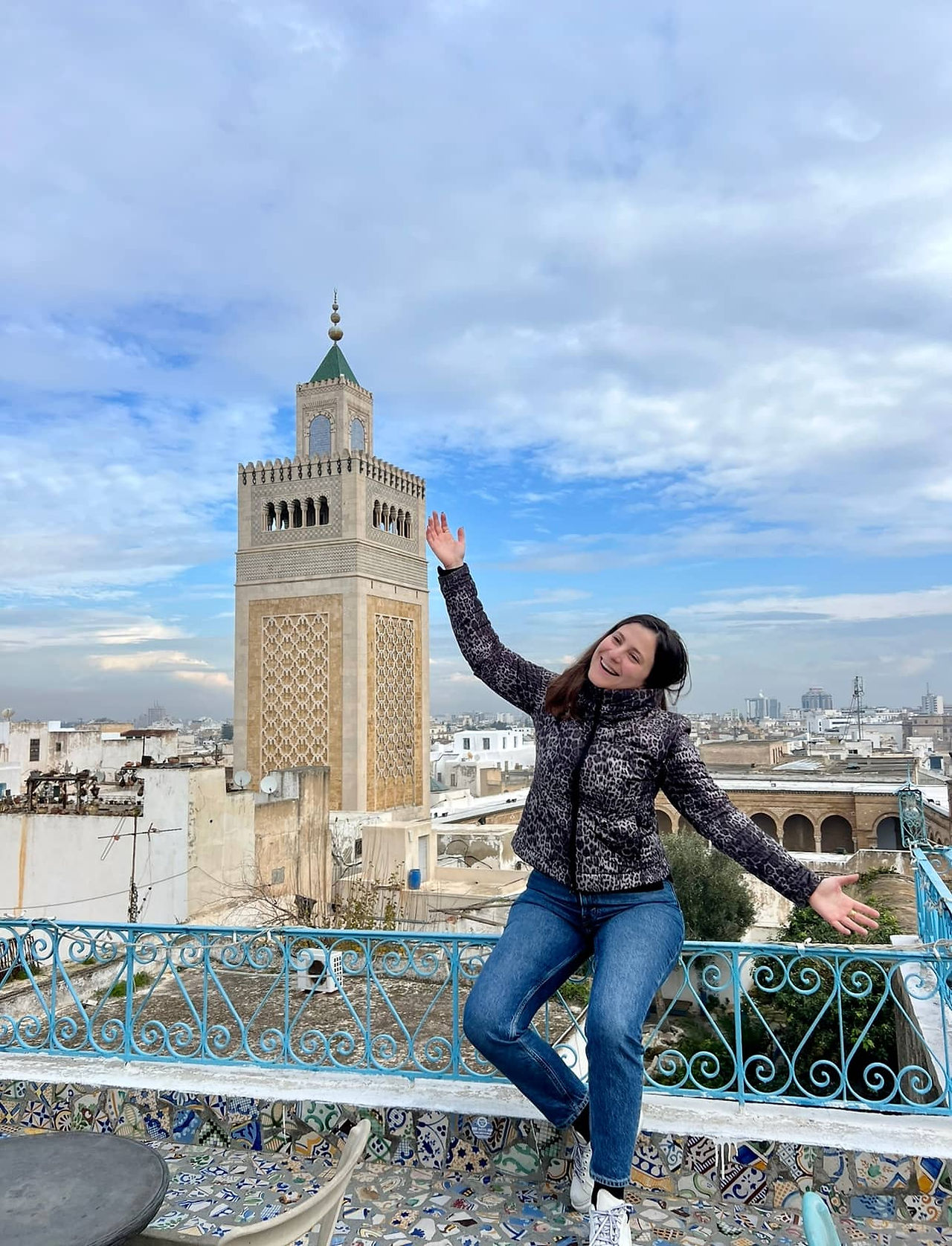 Traveler overlooking the skyline of Tunis from a rooftop terrace