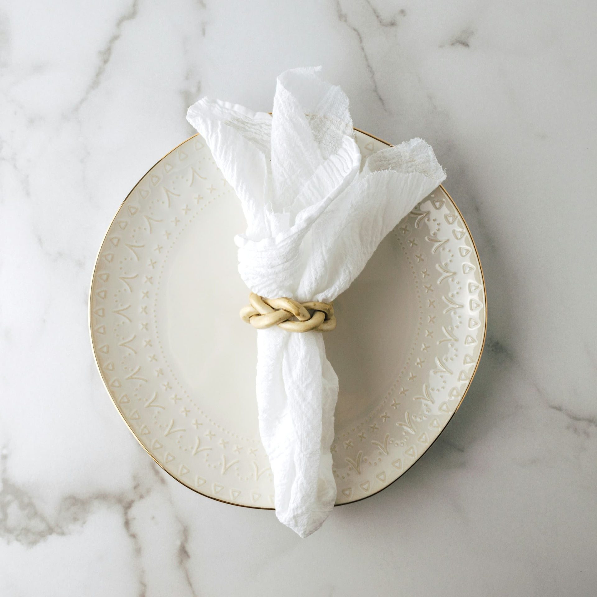 White ceramic plate and folded textile napkin reflecting material simplicity in Tunisian table culture
