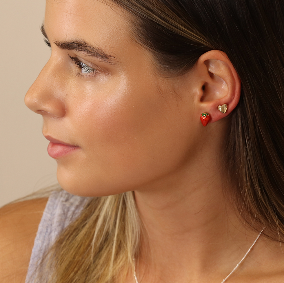 Lady wearing Strawberry and golden heart stud earring set