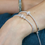 Thumbnail: Model wearing Silver plated triple mini crystal rings bracelet