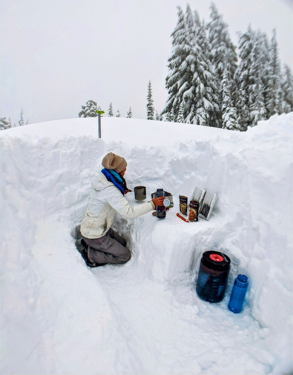 Backpacker making dinner in a kitchen dug out of snow