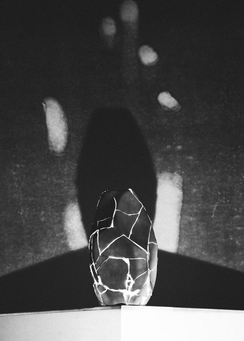Reassembled egg-shaped clay vessel with glowing cracks in kintsugi style, photographed in the dark to evoke healing and rebirth. Final piece in Things We Held in Silence by Alexander Libotte, shown at Malta Biennale 2026.