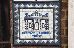 Artist Tamara Froud's HOLT logo mosaic at Barking workhouse plaque