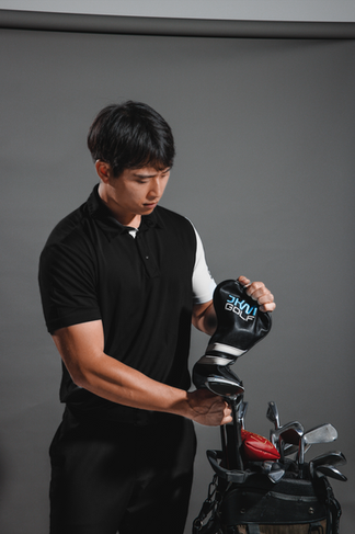 Male holding a gold club