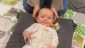 Baby enjoys a gentle therapy session for head tilt, highlighting the importance of staying consistent with treatment.