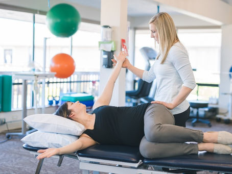 Physio giving patient exercises for cancer rehab