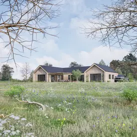 A serene countryside landscape featuring a modern, minimalist home nestled amidst lush greenery, blooming wildflowers, and mature trees under a partly cloudy sky. The house features larch cladding and a green oak frame, and has 4 bedrooms. It is built using sustainable materials and offers a blend of natural beauty and architectural elegance