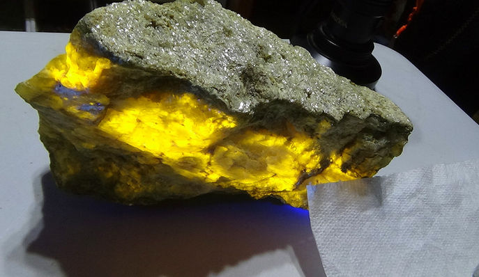 picture shows a lump of wernerite under fluorescent light - found at the Gooderham rock dump.