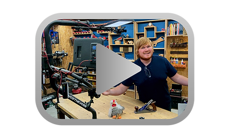 Aaron and Chicken at the workbench inside a YouTube play button
