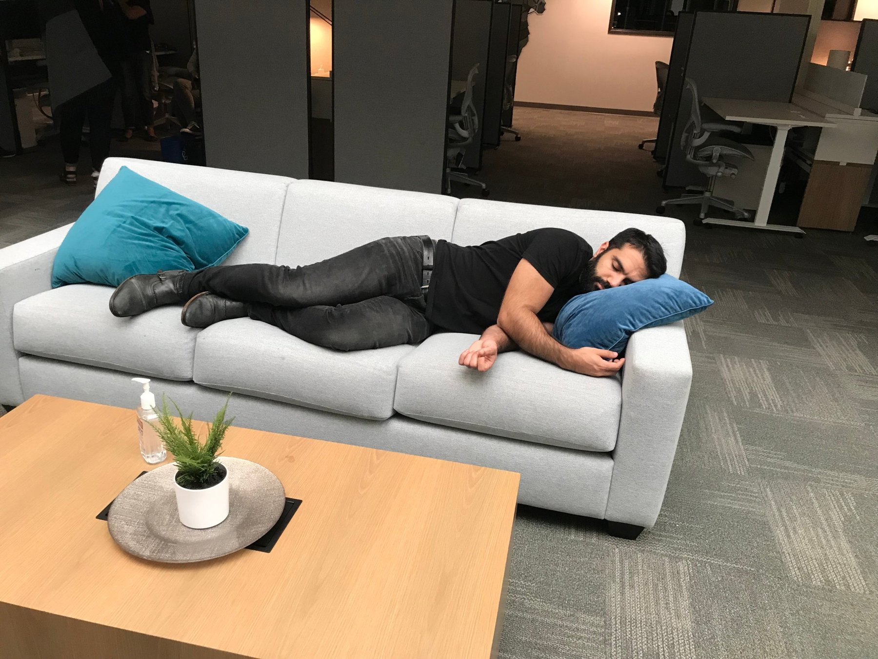 A crew member asleep on the studio couch