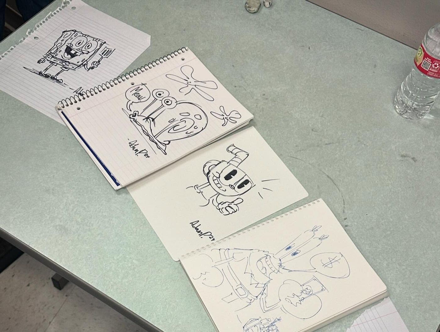 Quick pen drawings of SpongeBob, Gary, Cuphead and Mr. Krabs that Adam drew in students' sketchbooks