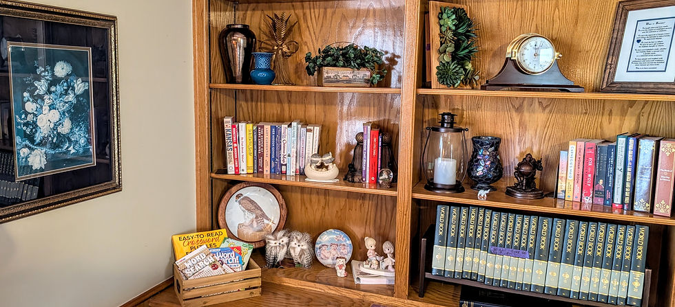 A bookshelf full of books and decor, prepared to be sold through an Integrity estate sale.