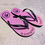 Thumbnail: Pink Parri Jamaica flip-flops with black straps and palm logo, place on poolside.