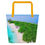 Thumbnail: Large polyester Jamaica beach tote with tropical coastline print, black straps, machine washable with interior pockets.