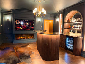 Custom-built home bar with handcrafted timber cabinetry and integrated lighting.