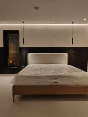 Luxury bedroom with half panelled solid ash walls and bespoke interior detailing