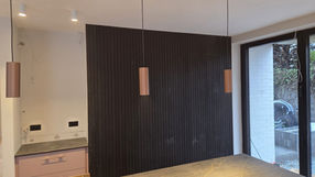 Bespoke interior fit-out with hidden doors, wall cladding and custom pantry joinery