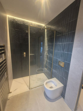 Modern luxury bathroom with walk-in shower and premium porcelain finishes.
