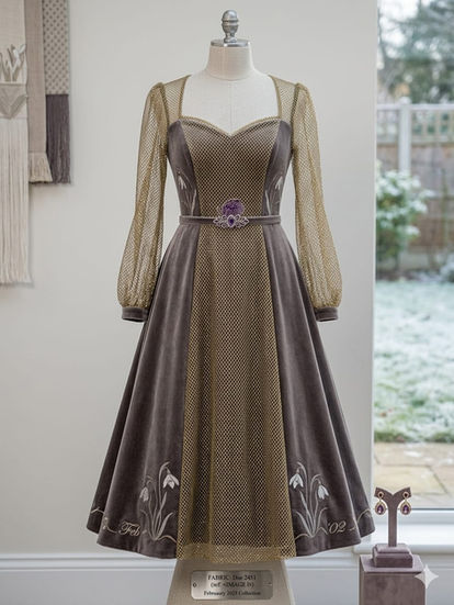Elegant long-sleeve dress with floral embroidery details.