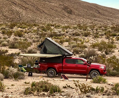 truck wedge style camper in the desert