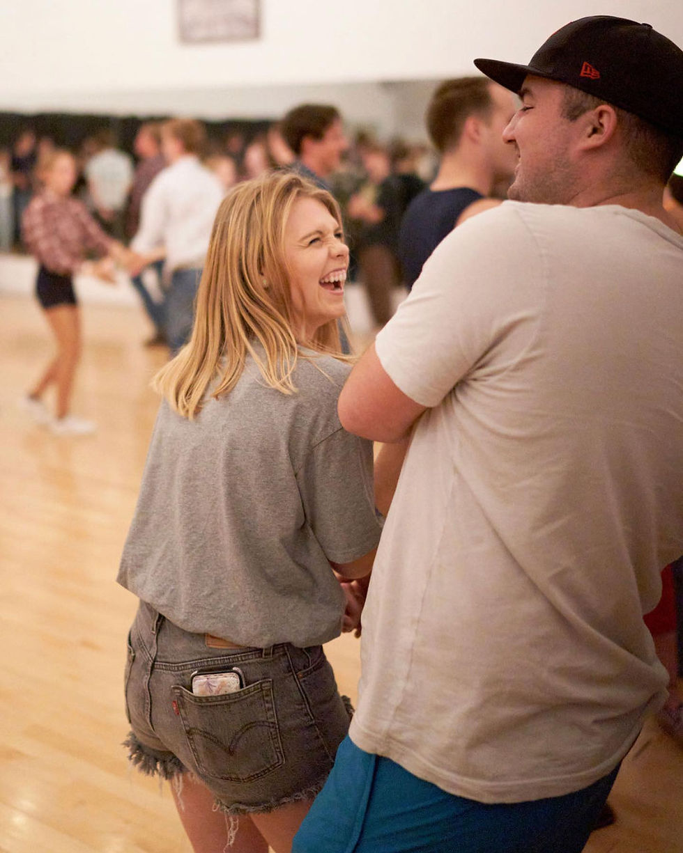 A couple laughs while they attempt a new move.