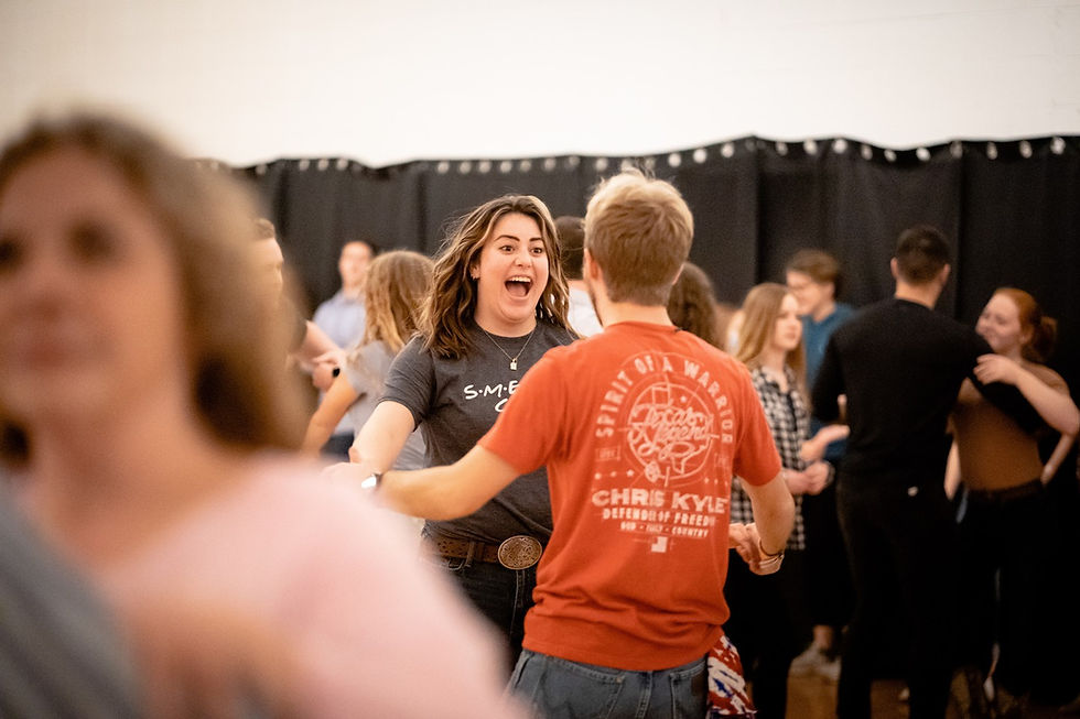 A couple laughs while trying out new dance moves.