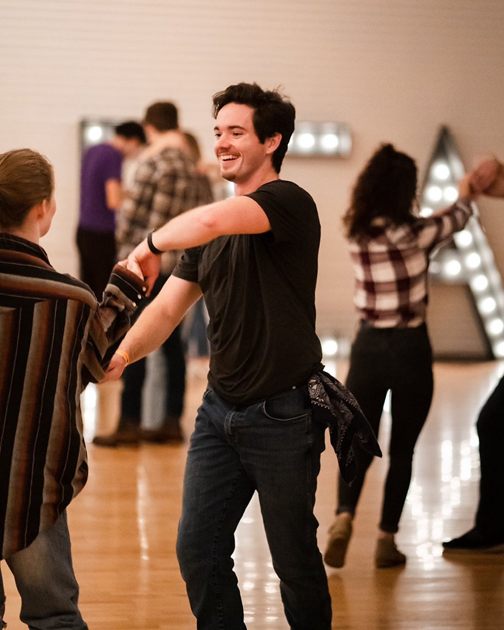 A couple spinning while doing the pretzel.