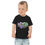 Thumbnail: A toddler wears a black tee shirt with a colorful graphic design on it.