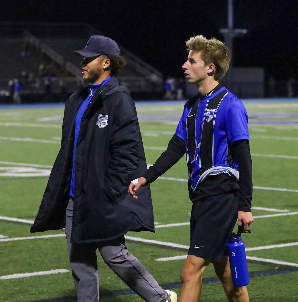 Coach Turner walks with Drew Emmendorfer.