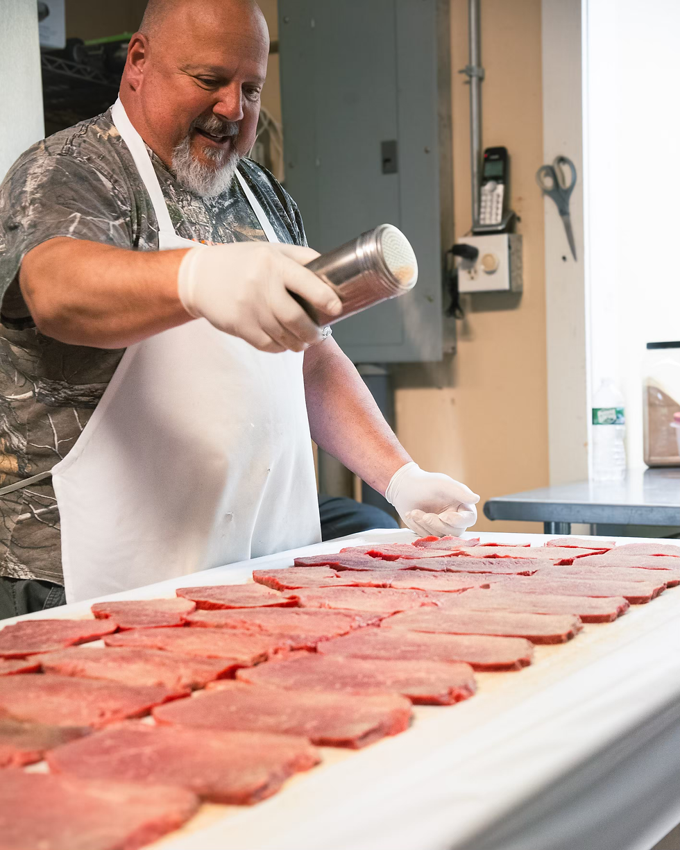 Seasoning the steaks before drying. ASHLYNN MCGRAIL PHOTO