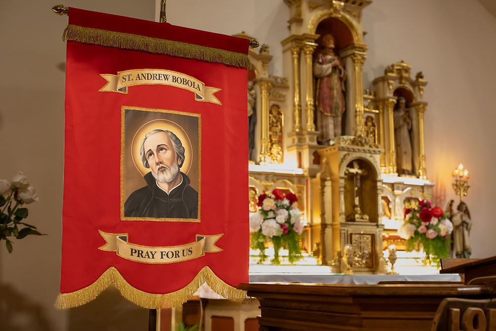 Red banner with image of Saint Andrew Bobola, "Pray for Us" text. Ornate altar with statues and flowers in the golden church background.