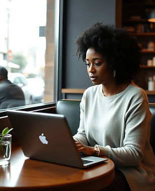 black woman sitting in a coffee shop wit