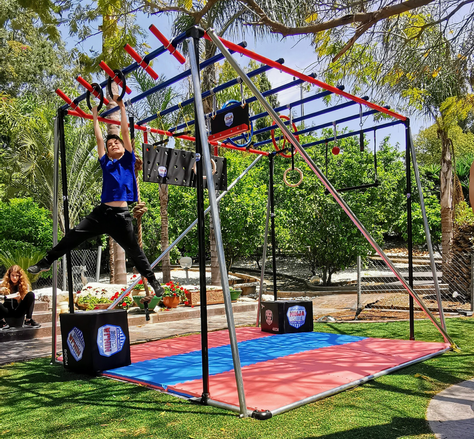 A freshly painted ninja rig with a child training happily and hanging from a bar.