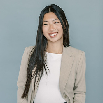 Young woman smiling and posing for her headshot.