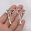 Thumbnail: Silver Squiggle Bows Dangle Earrings