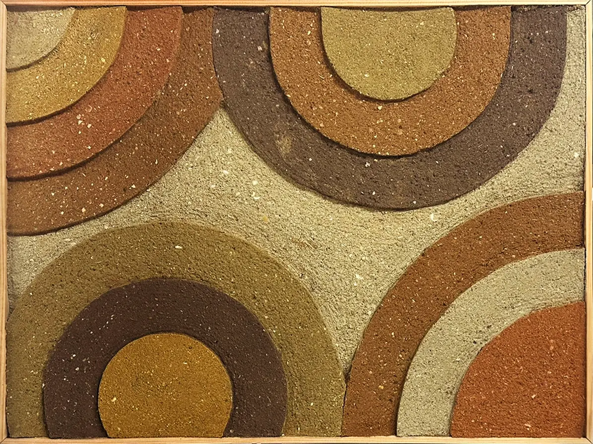 一幅正方形的室內裝飾藝術，展示了複雜的左官抹灰技法。畫面上由四組不同色澤的同心圓弧組成，分別位於畫面的四個角落向中心延伸。泥土顏色包含土黃、深棕、磚紅與灰泥色，圓弧之間疊加出明顯的立體厚度與層次感，背景則為粗顆粒的淺色泥土質地。