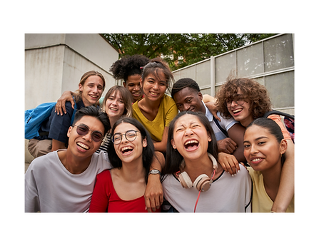 A group of diverse, smiling students gathered together outdoors.