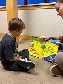 Client and therapist read a book during a therapy session