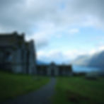 Photograph of an old abandoned Irish Institution set against the backdrop of a mountainous valley with a lake at its centre