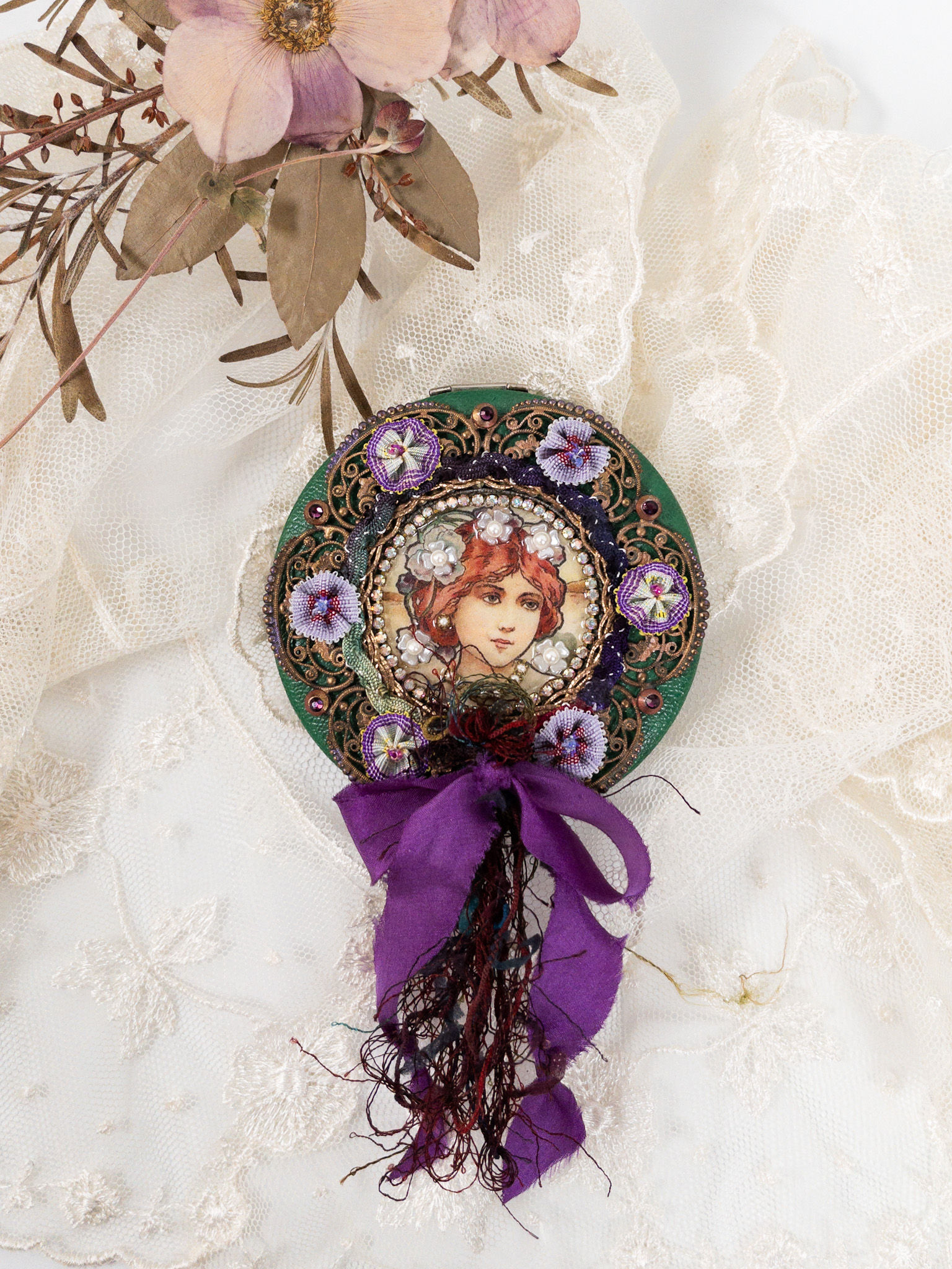 Vintage round leather compact front view embellished with brass filigree, girl image, rhinestones, fiber, trim, green-purple