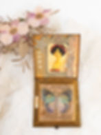 Vintage square brass compact inside view embellished with word "hope" and images of a young girl, star, key and  butterfly